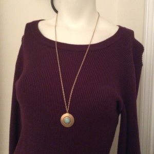 Gold tone necklace with gold/ blue pendant